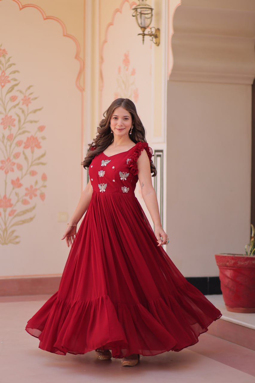 Lavi 7-meter flared designer gown in faux blooming fabric with sequin & bead embroidery, V-neck & frill shoulders – perfect for weddings & parties.